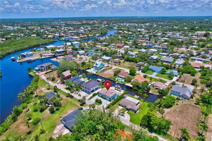 Aerial view of property's location featuring nearby suburban area and a nearby body of water