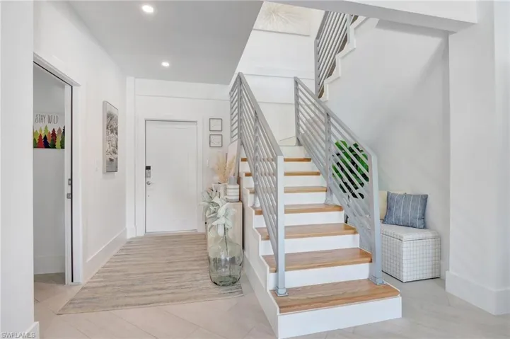 Stairway with baseboards and recessed lighting
