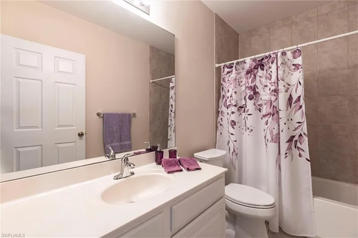 Bathroom with vanity, toilet, and shower / bath combo