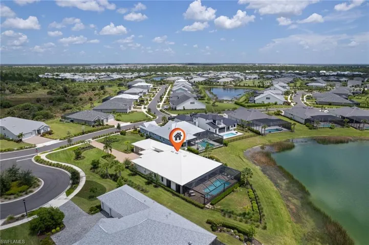 Birds eye view of property with a water view