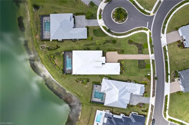 Birds eye view of property with a water view