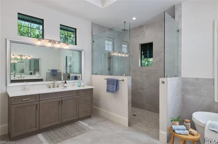 Bathroom featuring tile patterned flooring, independent shower and bath, and vanity