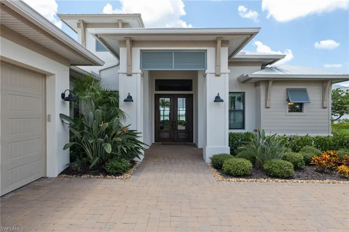 View of exterior entry featuring a garage and french doors