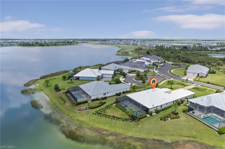 Birds eye view of property with a water view