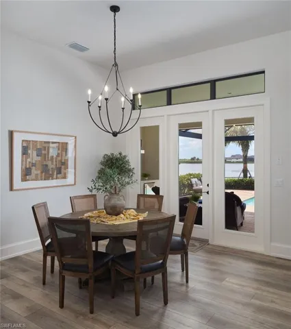 Dining room featuring an inviting chandelier and wood-type flooring