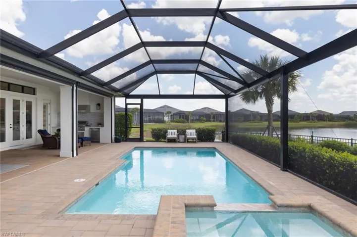 View of pool featuring a patio and a lanai