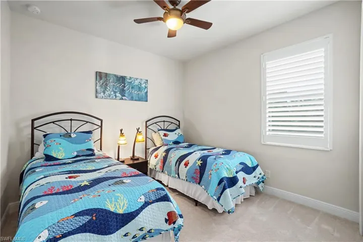Neutral wall color, ceiling fan, with plantation shutters, and carpeted flooring