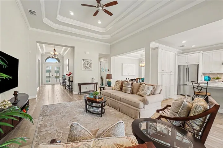 Tray ceiling with recessed lighting and crown molding.
