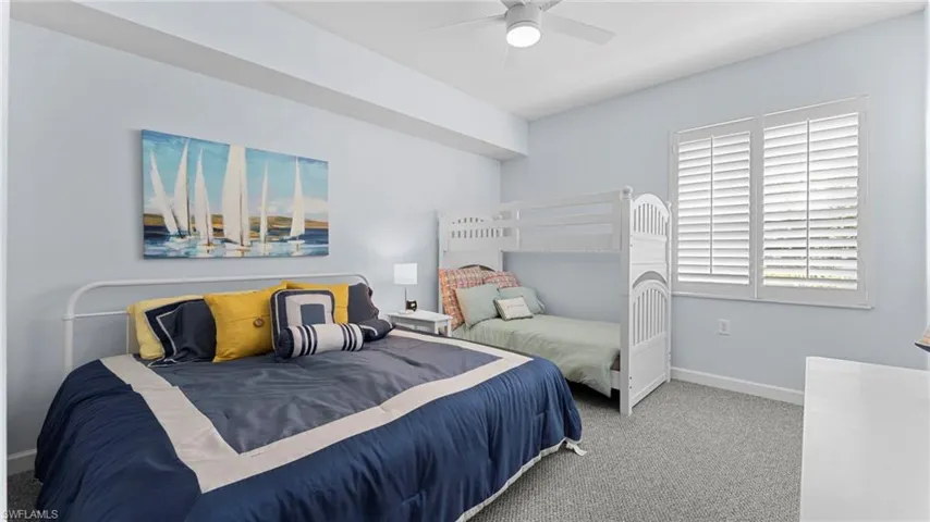 Bedroom with ceiling fan and carpet flooring