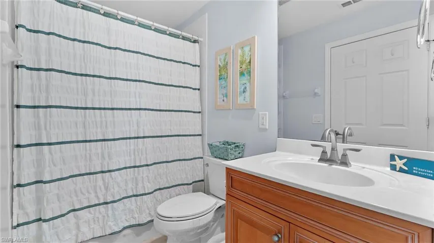 Bathroom with walk in shower, vanity, and toilet