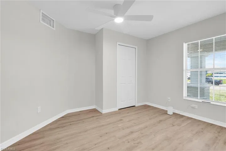 Spare room with light wood finished floors and a ceiling fan