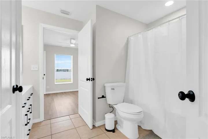 Bathroom with toilet and tile patterned floors