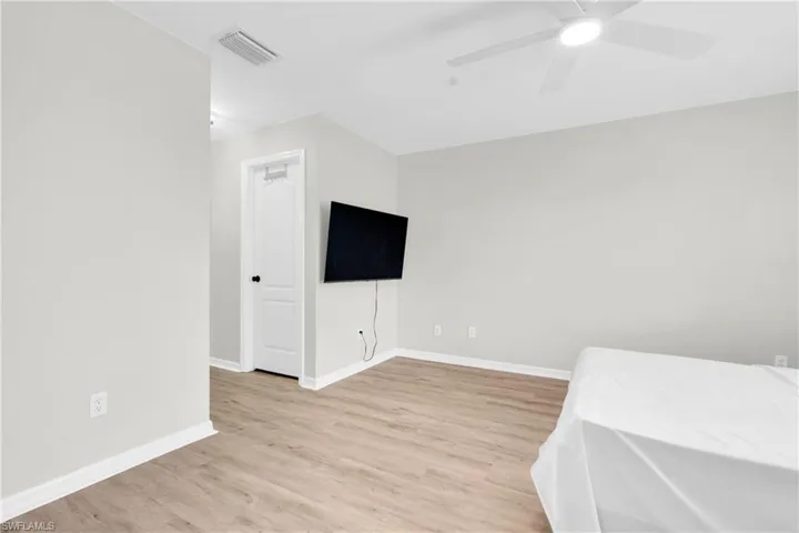 Unfurnished bedroom with light wood-style floors and a ceiling fan