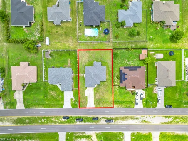 Aerial view of residential area featuring property boundaries highlighted