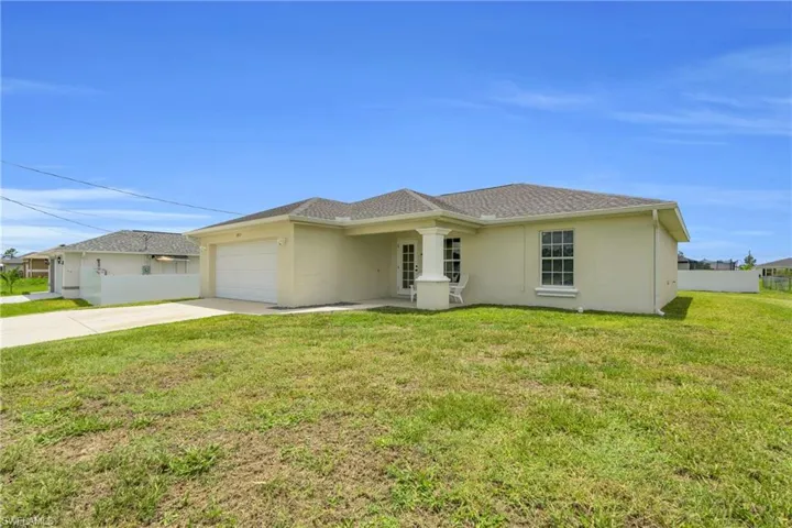 Ranch-style home with driveway, an attached garage, and stucco siding