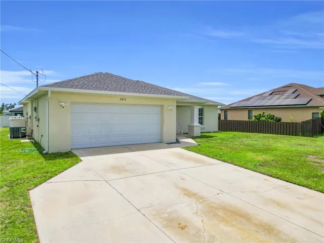 View of front of house featuring stucco siding, concrete driveway, roof with shingles, and an attached garage