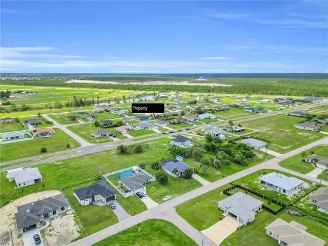 Aerial overview of property's location with nearby suburban area and a nearby body of water