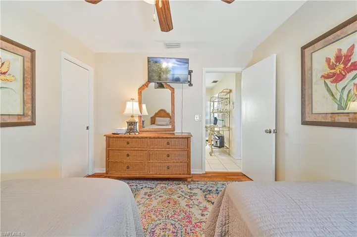 Bedroom featuring light tile patterned floors and ceiling fan