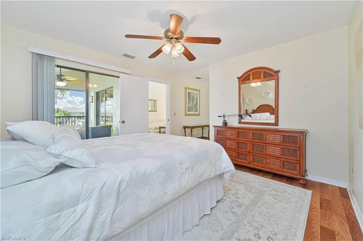 Bedroom featuring light hardwood / wood-style flooring, ceiling fan, and access to exterior