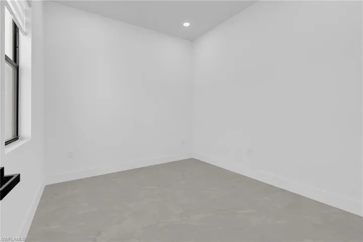 Mother-in-law bedroom featuring finished concrete flooring and recessed lighting