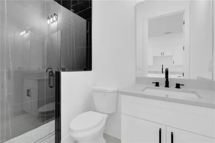 Full Guess bathroom featuring a stall shower and vanity
