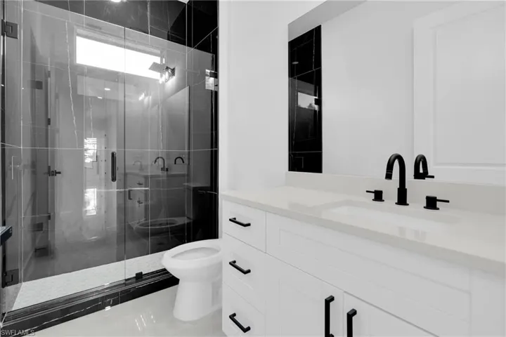 Mother-in-Law Full bath featuring vanity and a shower stall
