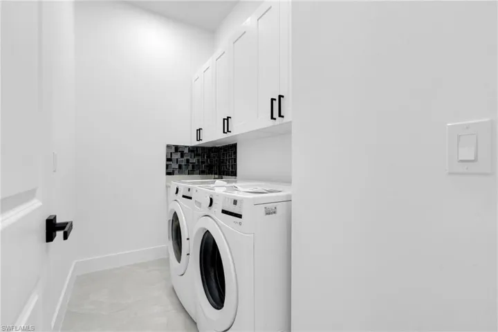 Laundry area with cabinet space and washing machine and dryer