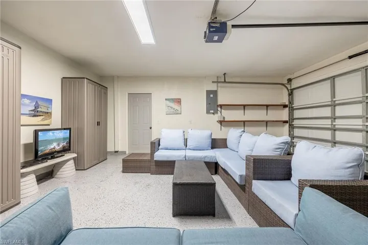 Garage featuring a garage door opener and electric panel