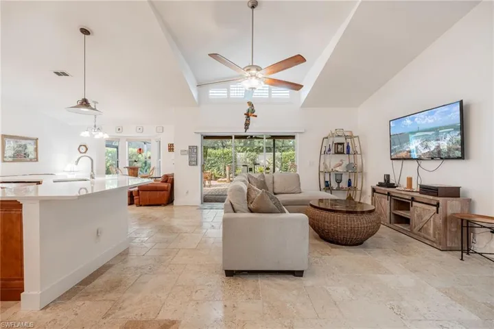 Open concept with vaulted ceilings and a view out to the pool