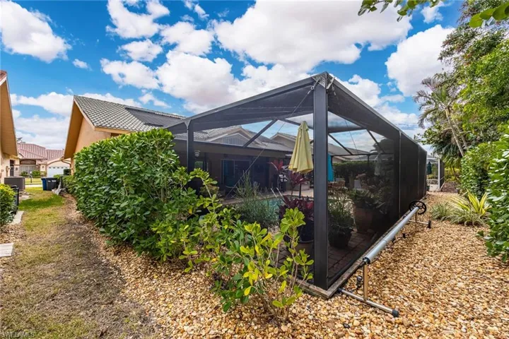 View of home's exterior with glass enclosure