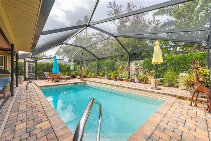 Beautiful screened in pool with lush landscaping and privacy