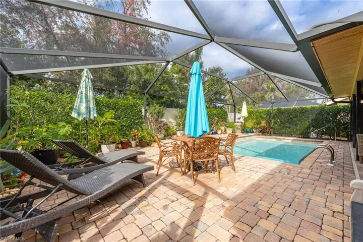 View of swimming pool with a lanai and a patio area