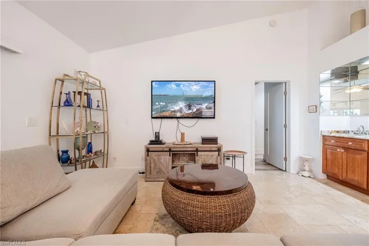 Living room with wet bar and high vaulted ceiling