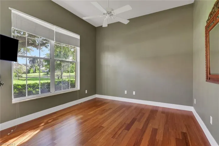 Spare room with wood finished floors and ceiling fan