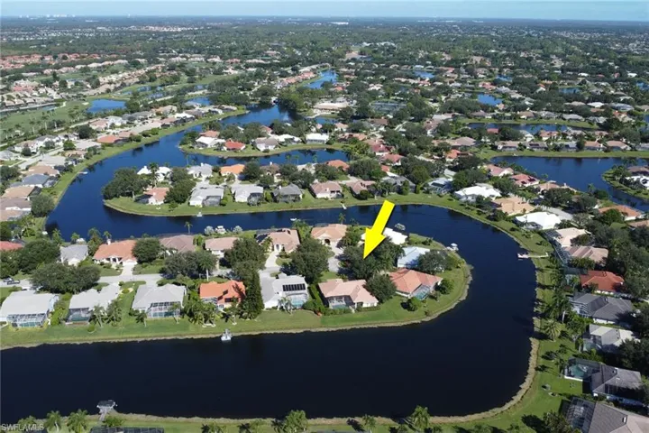 Aerial overview of property's location with a large body of water and nearby suburban area