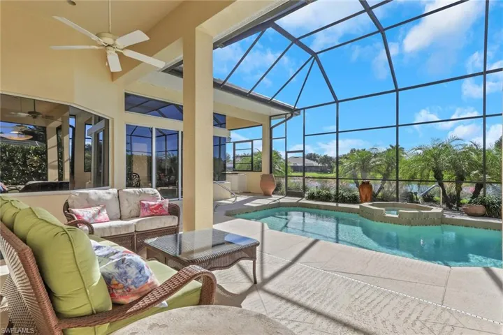 View of swimming pool featuring a patio, a sunroom, a ceiling fan, a lanai, and outdoor lounge area