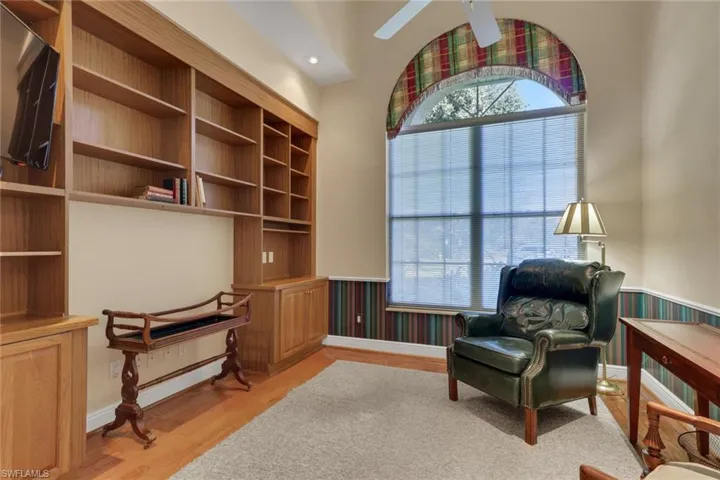 Sitting room with wainscoting, light wood-type flooring, recessed lighting, and a ceiling fan