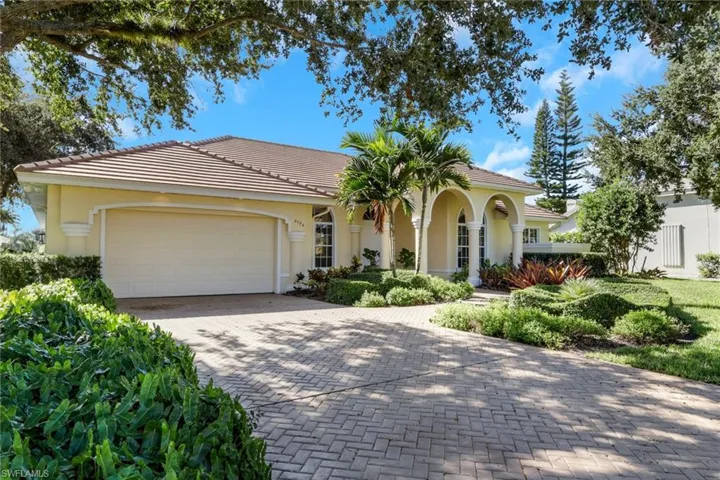 Mediterranean / spanish home with decorative driveway, stucco siding, an attached garage, and a tile roof