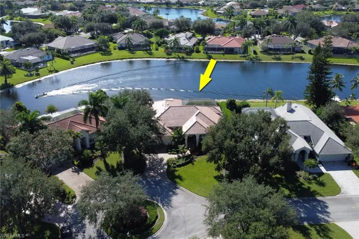 View of property location featuring a large body of water and nearby suburban area