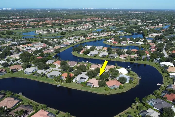 Aerial overview of property's location with a large body of water and nearby suburban area