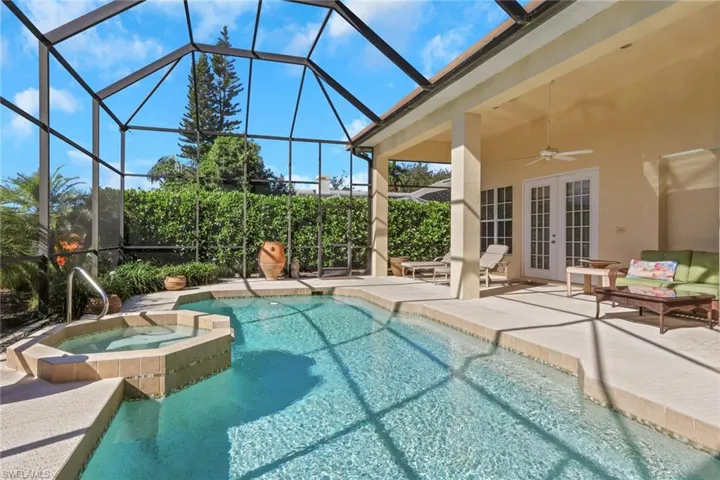 View of swimming pool with ceiling fan, french doors, a patio area, a sunroom, and glass enclosure