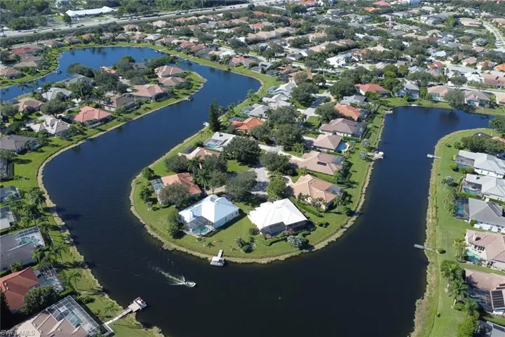 Aerial overview of property's location featuring a large body of water and nearby suburban area