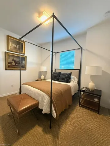 Carpeted bedroom featuring baseboards