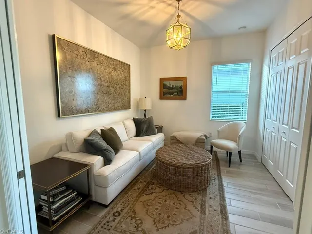 Living area with wood finished floors and baseboards