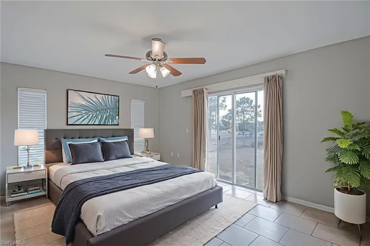 Bedroom with access to outside and a ceiling fan
