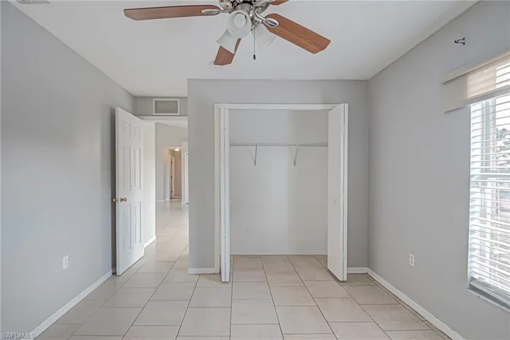 Unfurnished bedroom with a closet and a ceiling fan