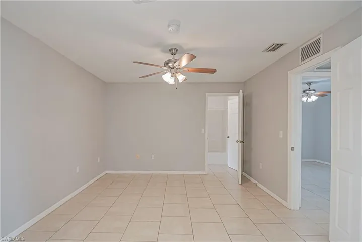 Unfurnished room featuring ceiling fan and light tile patterned floors
