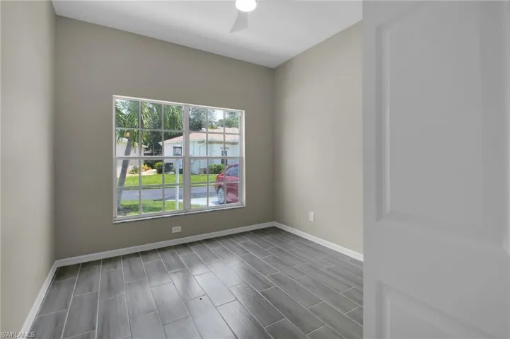 Empty room with ceiling fan and wood-type flooring