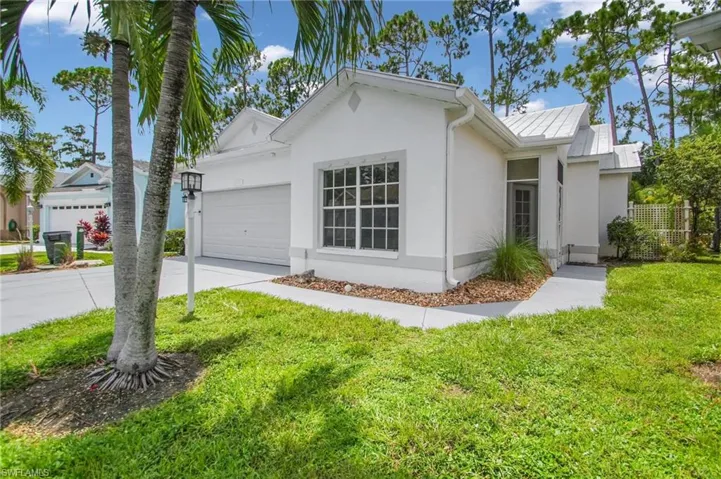 Ranch-style house featuring a garage and a front yard