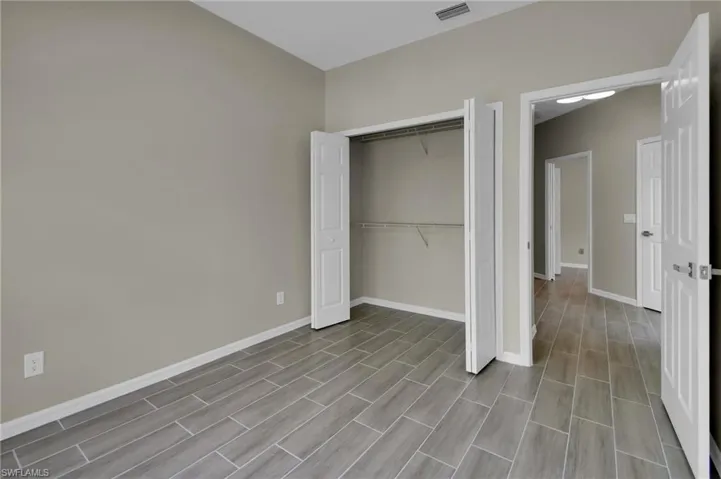 Unfurnished bedroom with light hardwood / wood-style floors and a closet